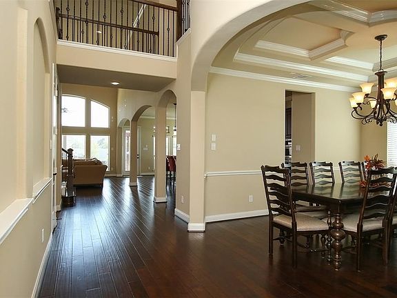 Enter through the eight foot mahogany front door with grille to high ceilings and rich wood floors.