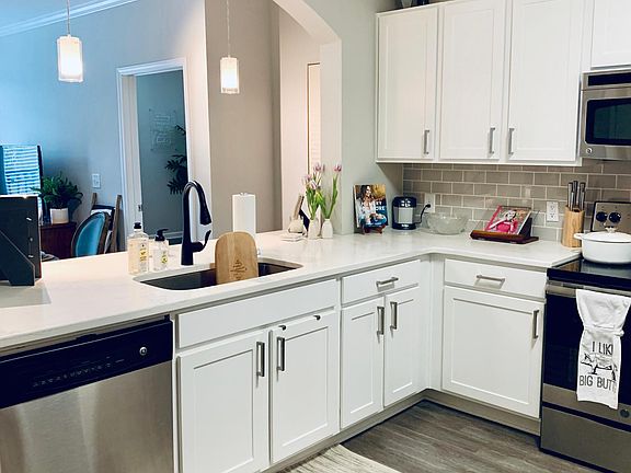 All-white updated kitchen with stainless steel appliances