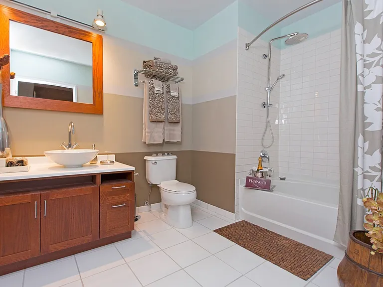 63 E Lake Apartments bathroom with walnut cabinetry