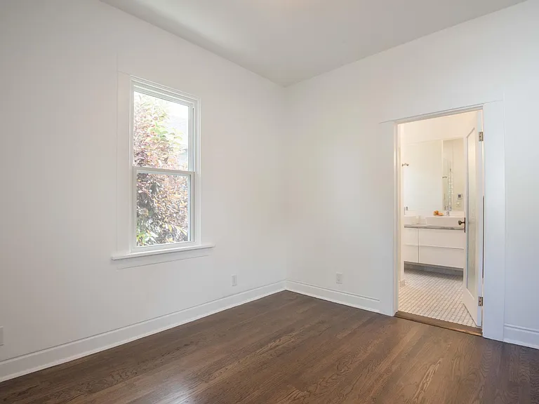 Primary bedroom with view of bathroom.