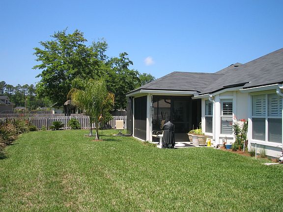 large fenced yard with custom wood shed