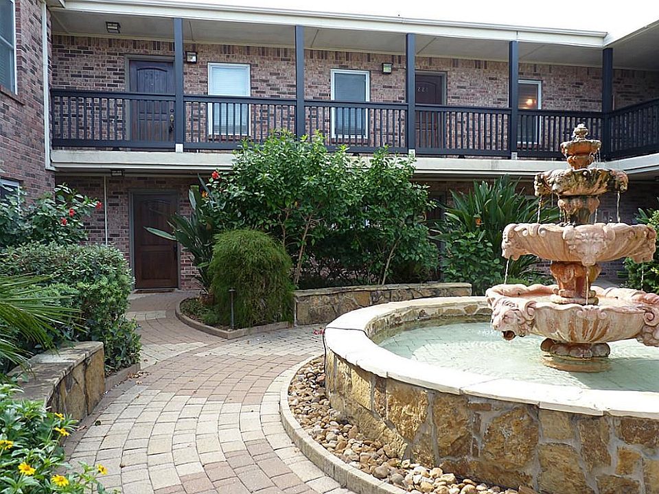 Your front door and living room overlook the lush courtyard with fountains and pool.