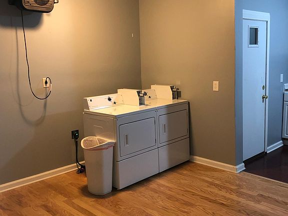 Laundry room with two coin operated washers and two coin operated dryers.