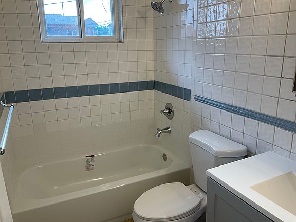main bathroom with new tub, vanity, medicine cabinet
