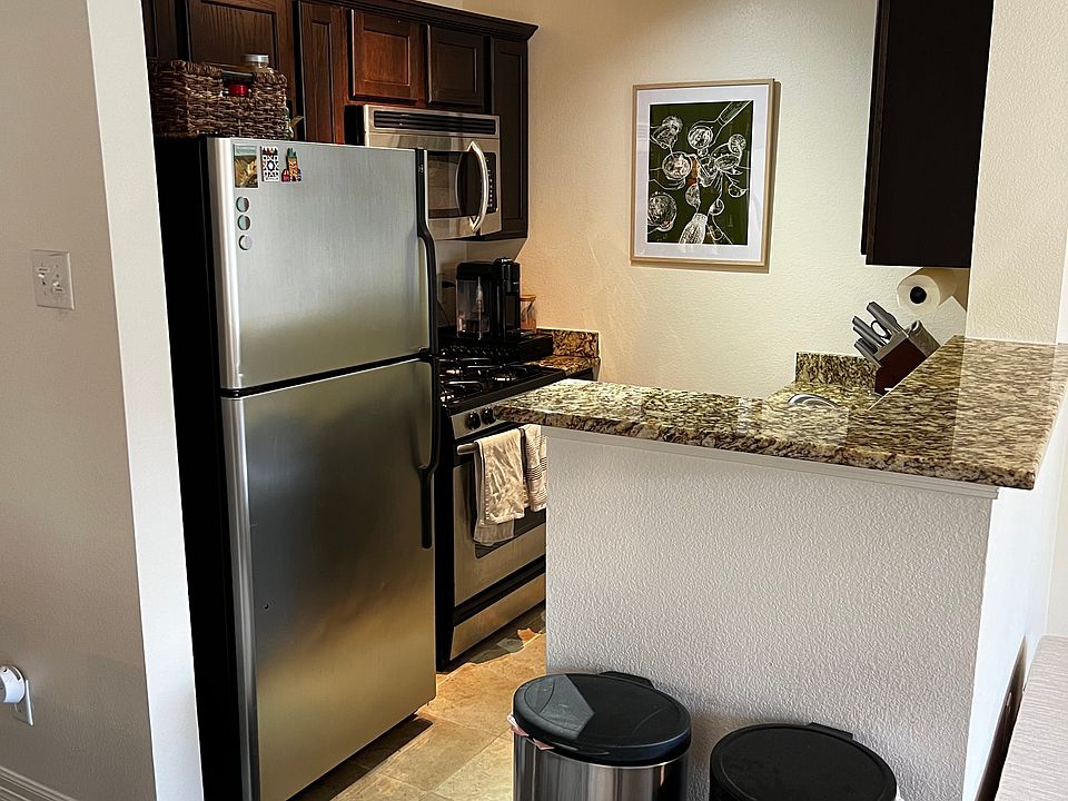 Kitchen w/ dishwasher, refrigerator, and gas stove.