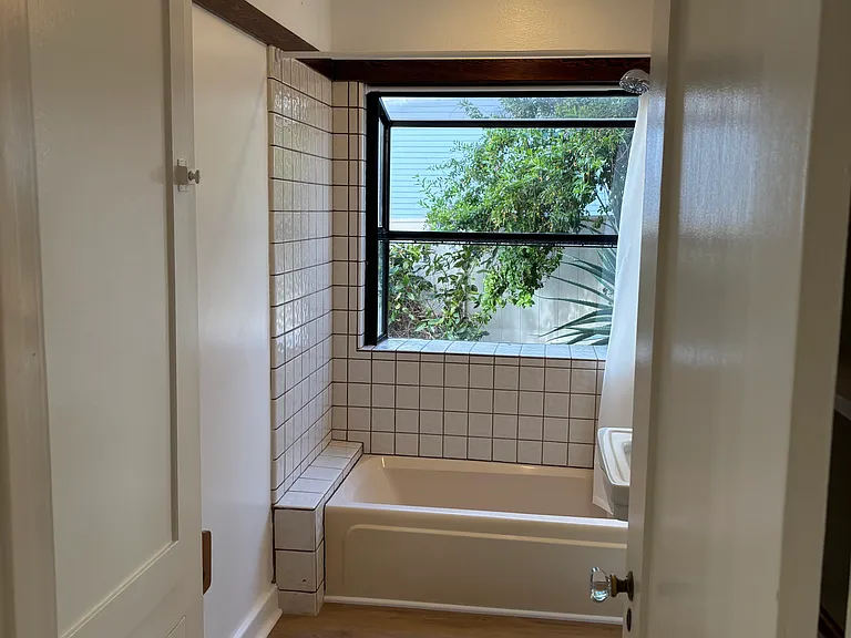 Hall bathroom. Lots of storage on the left and behind the door on the right.