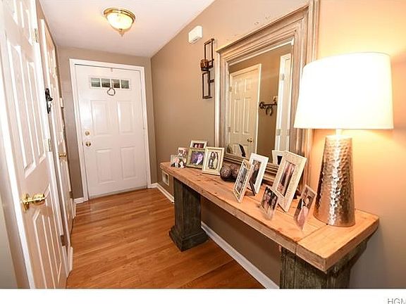 Entry foyer with hardwood floors and large closet.