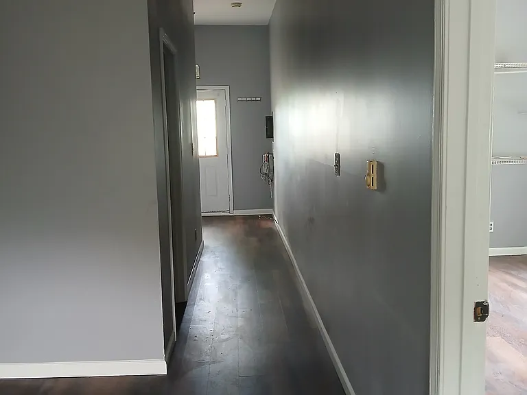 Hallway, looking out - bedroom door on right, bathroom door on left, entrance straight ahead