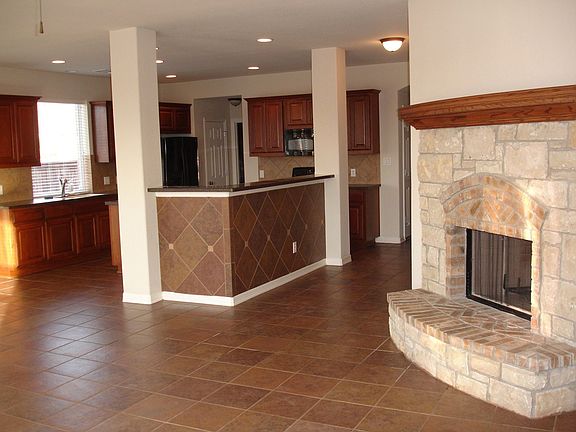 From the living room, the fireplace and kitchen