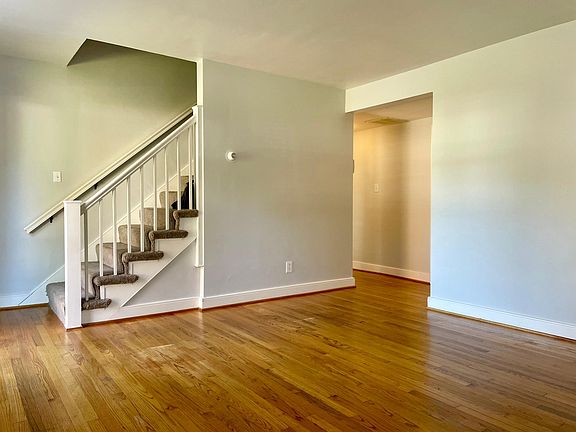 Family room looking into the main hallway going to kitchen on right, downstairs bath on right, pantry on left, master bed room on left.
