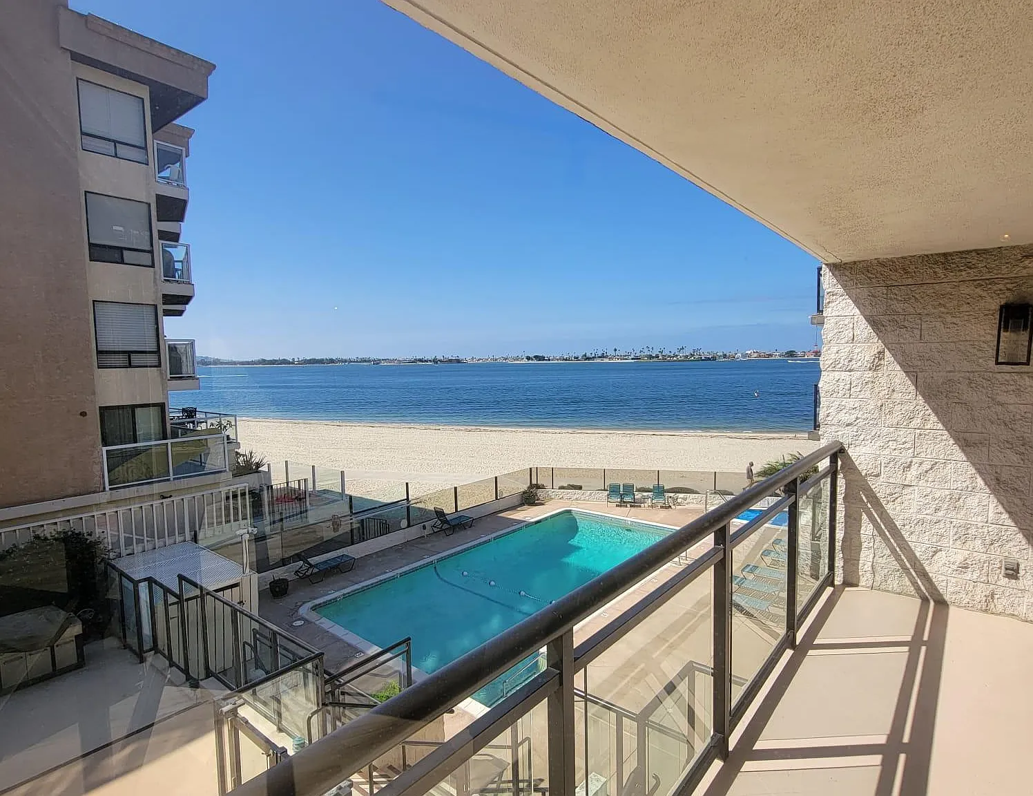 balcony overlooking the water and pool