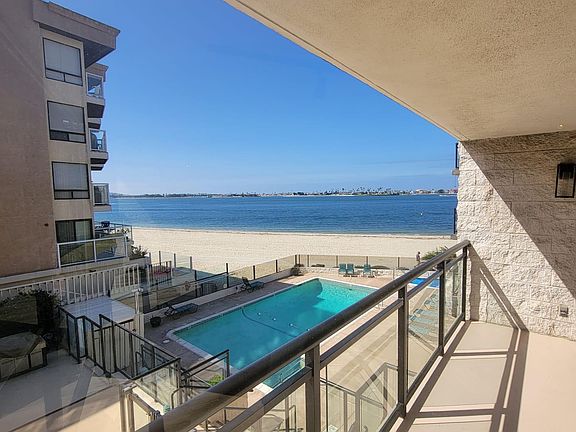 balcony overlooking the water and pool