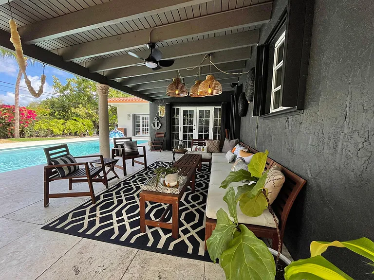 Back patio has room for plenty of people to seat by the pool.