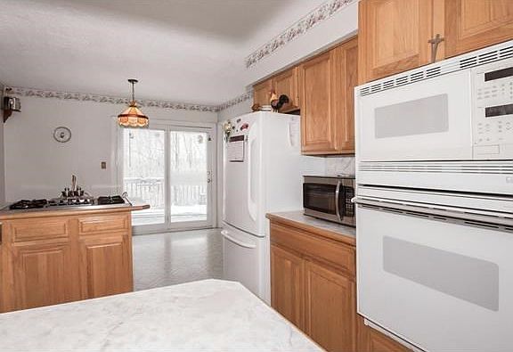 Open Kitchen with Breakfast Nook and Slider to the wrap around deck.