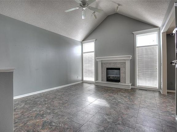 Great room with vaulted ceiling and fireplace