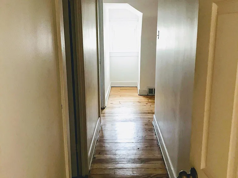 Second floor hallway with refurbished hardwood floor