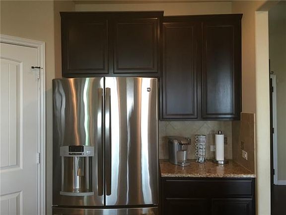 Wonderful dark wood cabinets with ample granite countertops.  (G