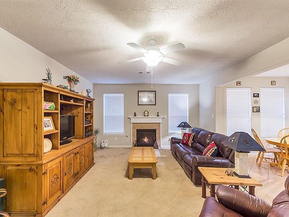 The den is open to the kitchen and breakfast area.