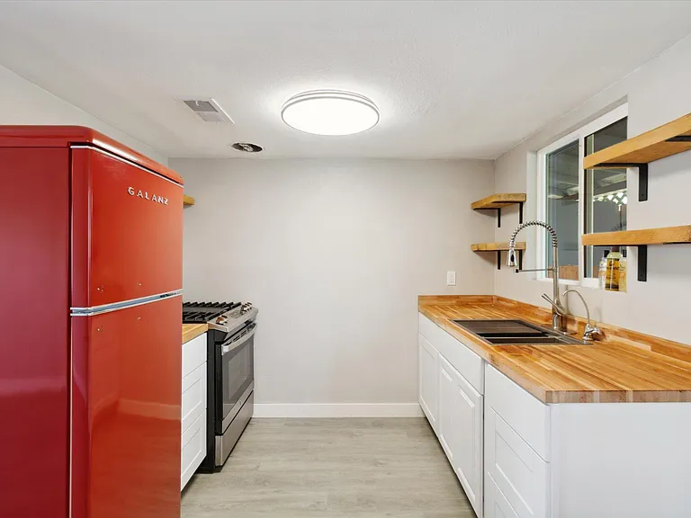 Brand new retro refrigerator with custom cut countertops and shelves.