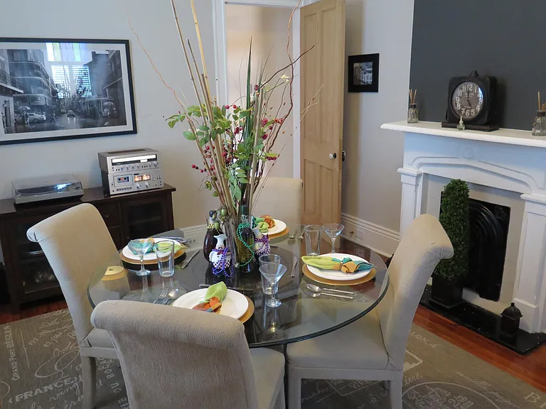 Black accent wall over the fire place and a table ready to welcome guests!