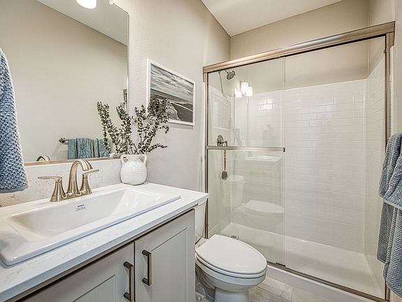 First floor full bathroom with single vanity oversized easy-care shower