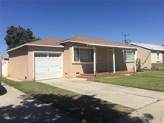 Showing the left side of the home with side entrance to backyard next to garage