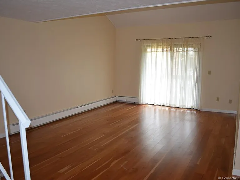 Large living room with sliders to balcony