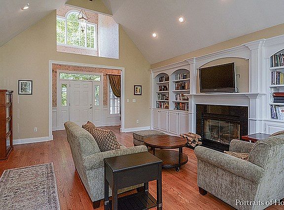 Custom built-in cabinetry & wood burning fireplace w/gas start~All wood flooring recently refinished