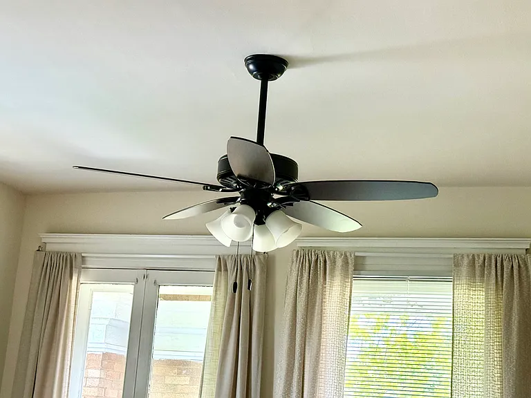 The living room has ceiling fan. The double French doors open onto the private balcony. The cross ventilation with the large windows create wonderful breezes.