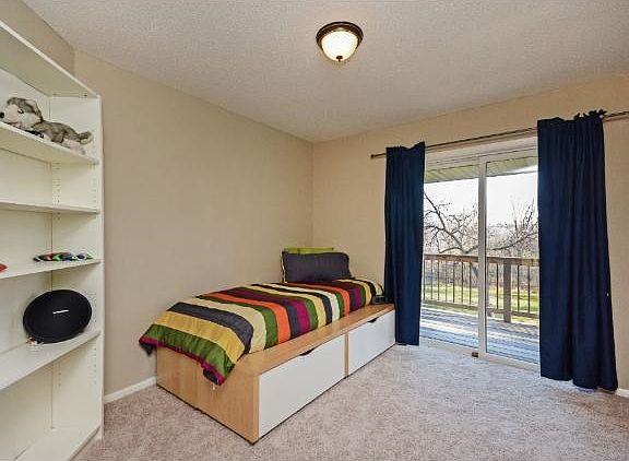 Upper level bedroom with a great view of the backyard and regional trail.