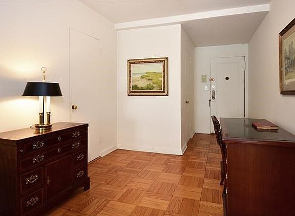 View of large entryway toward the front door, huge pantry closet to the left and room for office are