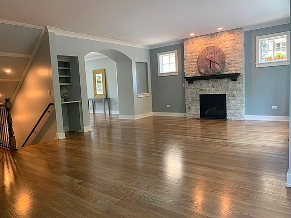 hardwood flooring with gas fireplace. bar and wine storage
