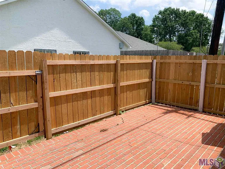 Fenced privacy patio has electrical outlets for you to enjoy or entertain.