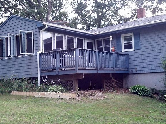 Rear view from Brush Hill, showing deck off 3 season room.