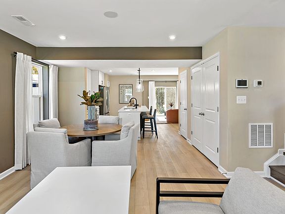 Step into a spacious entryway with stairs and a cozy seating area for welcoming guests.