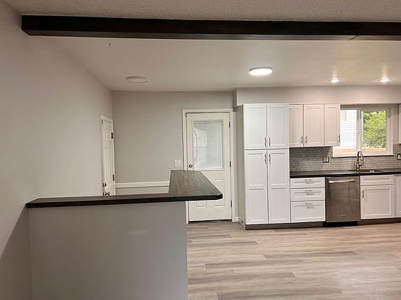 Bar countertop area in kitchen. view of stairwell and back door.