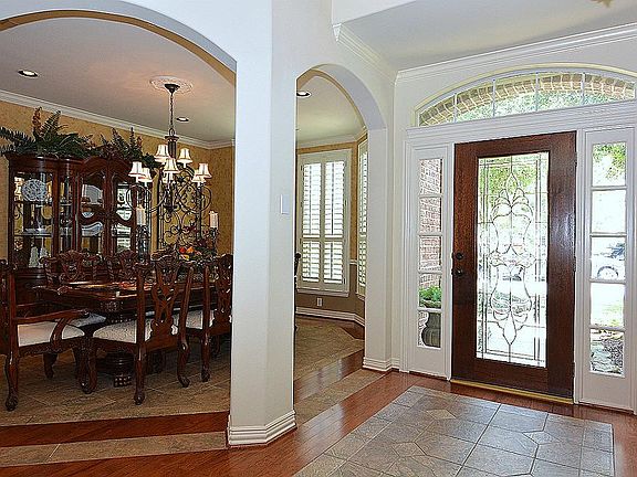 Impressive Grand Entry flanked by Formal Dining and Study with CUSTOM tile and wood Flooring.