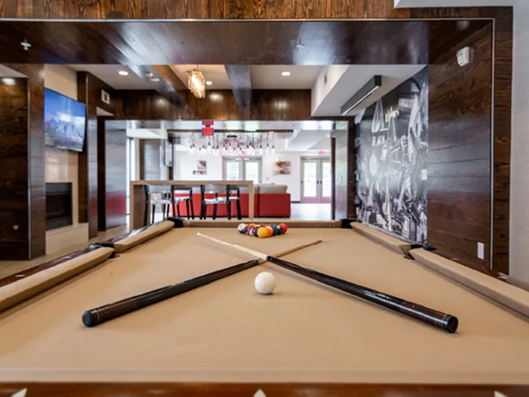 Resident clubhouse with billiards table and lounge space.