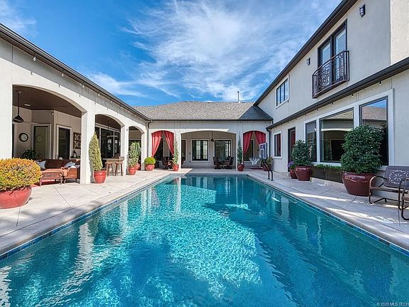 Pool with covered patios, hot tub, dining area, drink cooler, sink and grill