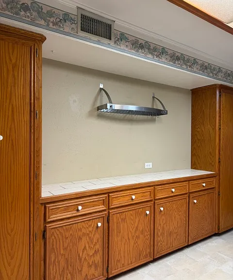 east wall features counter workspace, cabinets, and two pantries