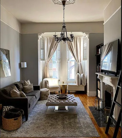 Living room. Fireplace is not functional. Library bookcases and ladder remain with unit.
