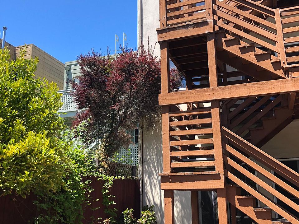 View of the balcony and stairs to shared yard.