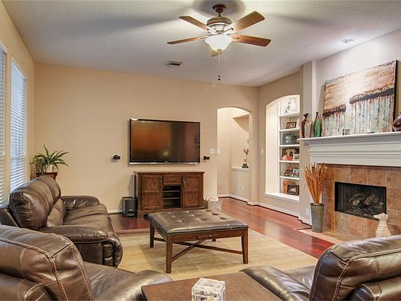 Family room with fireplace, built-ins and gorgeous wood floors.