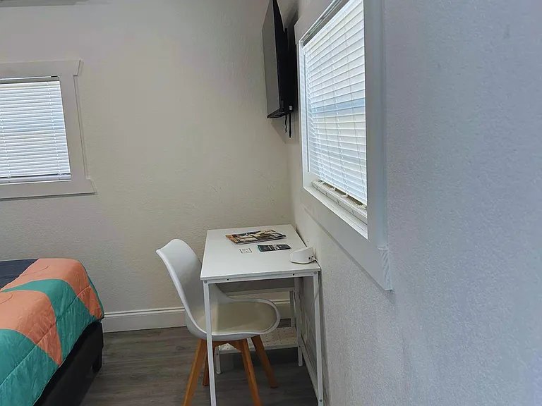Room with study desk, chair and excellent lighting.