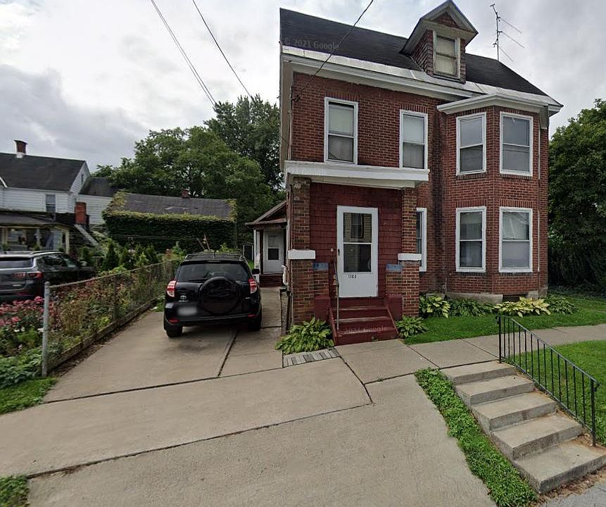 Brick Home 
With a parking capacity for two cars, convenience is key, and additional free parking is available just around the corner, ensuring practicality and ease for residents and guests alike.