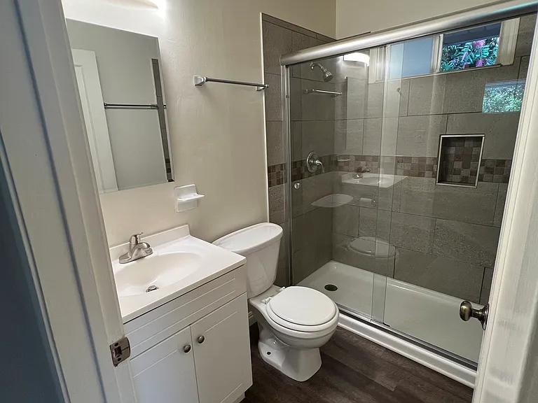 new medicine cabinet, faucet and lighting. Note the walk-in shower with window.