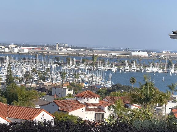 Bay channel view and marinas with sailboats. Watch cruise ships, cargo ships and Navy ships traverse the channel.