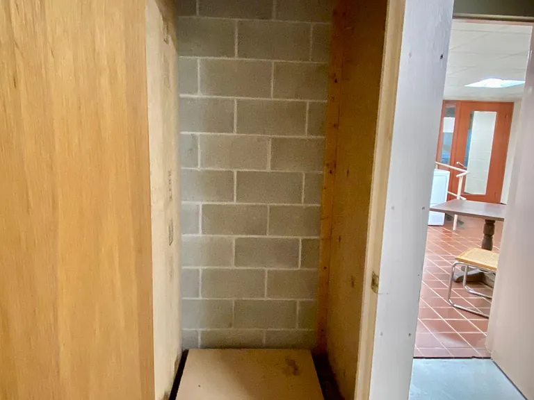 Storage room unit on garage parking level.