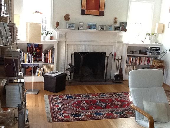 Living room with working fireplace, built in bookcases