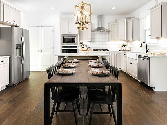 large dining room seating for entertaining with open concept kitchen